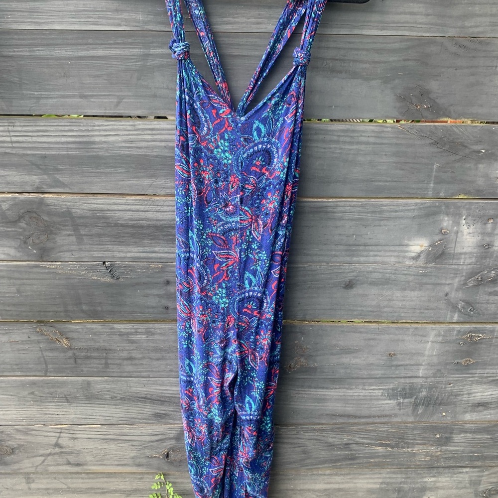 Jumpsuit, drapes in the back. The pictures do not do it justice. The legs bloom